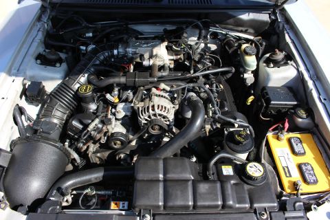 2002 Ford Mustang - Close-up view of a car's engine compartment, showing the V8 engine and its components.