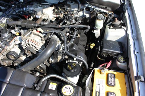 2002 Ford Mustang - Engine bay of a 2002 Ford Mustang, showing the V8 engine and associated components.