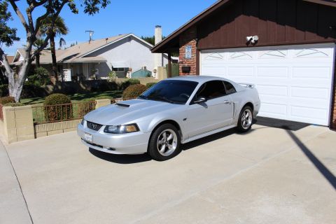 2002 Ford Mustang - Silver 2002 Ford Mustang parked in a suburban driveway.
