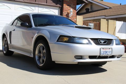2002 Ford Mustang - Front 3/4 view of a silver 2002 Ford Mustang with a hood scoop.