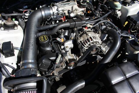 2002 Ford Mustang - Close-up of an engine bay an aftermarket K&N intake system and a Ford Mustang valve cover.