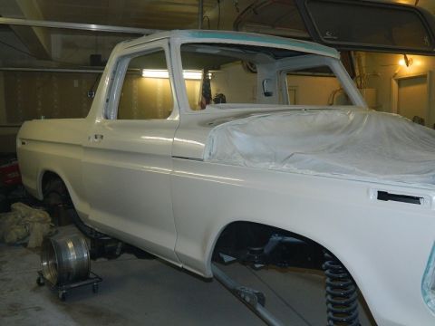 1979 Ford Bronco - This 1978 Ford Bronco is undergoing bodywork in a workshop, with plastic covering parts of the exterior.