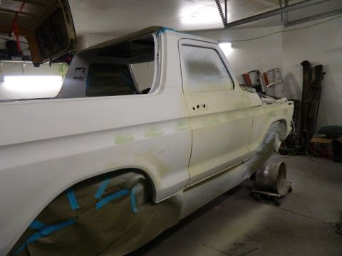 1979 Ford Bronco - A 1979 Ford Bronco is shown in a garage, undergoing preparation for a new paint job.