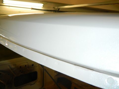 1979 Ford Bronco - The interior of a vehicle is shown with fresh white paint applied to the roof structure.