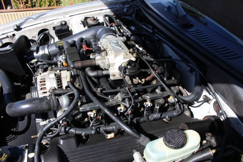 2002 Ford Mustang - Close-up view of the engine bay, showing the intake manifold and throttle body assembly.