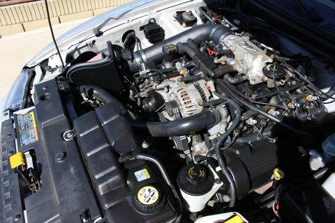 2002 Ford Mustang - The engine bay of a 2002 Ford Mustang shows an aftermarket intake system.