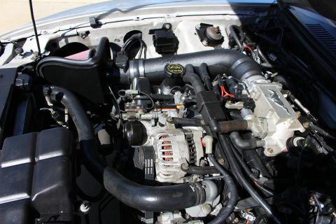 2002 Ford Mustang - Aftermarket intake and supercharger visible in the engine bay.
