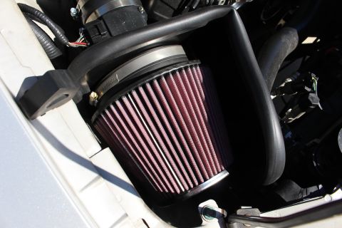 2002 Ford Mustang - Close-up of an aftermarket engine air intake filter system installed in a vehicle.