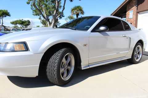 2002 Ford Mustang - Silver 2002 Ford Mustang GT coupe with tinted windows.