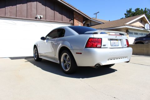 2002 Ford Mustang - Rear view of a silver 2002 Ford Mustang GT parked in a driveway.