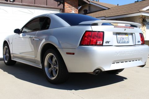 2002 Ford Mustang - Silver 2002 Ford Mustang GT with tinted windows and a rear spoiler.