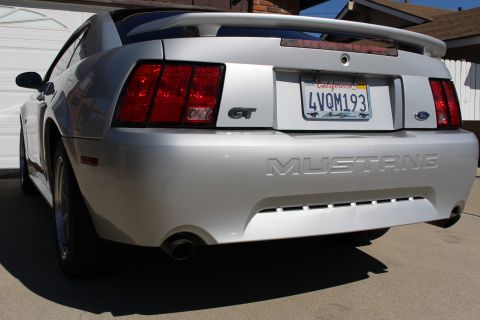 2002 Ford Mustang - Rear view of a silver 2002 Ford Mustang GT with a California license plate.