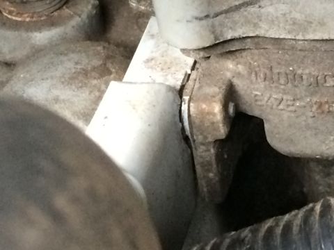 1989 Ford Bronco - A close-up view of an engine part, showing text and grime.
