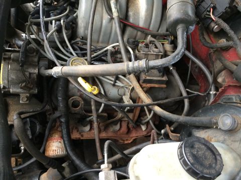 1989 Ford Bronco - Close-up of an engine bay, focusing on the oil filter and surrounding components.