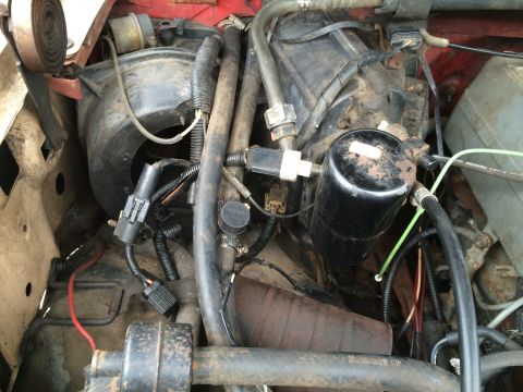 1989 Ford Bronco - Close-up view of engine compartment components, including hoses and wiring harnesses.