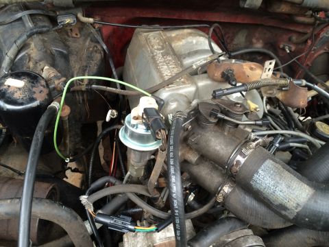 1989 Ford Bronco - Close-up view of a vehicle's engine bay, showing various components and wiring harnesses.
