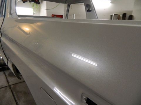 1979 Ford Bronco - The metallic silver paint on this vehicle's body panel is being examined.