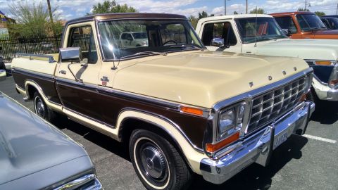 1979 Ford Bronco - Two-tone 1979 Ford F-150 pickup truck seen at a car show with other vehicles.
