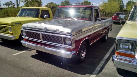 1979 Ford Bronco - A vintage Ford F-Series truck is parked next to other vehicles under a sunny sky.