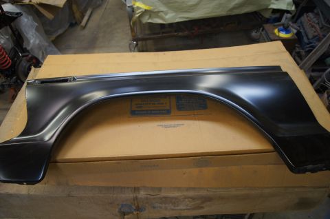 1979 Ford Bronco - A new car fender part is shown, resting on a box in a garage setting.