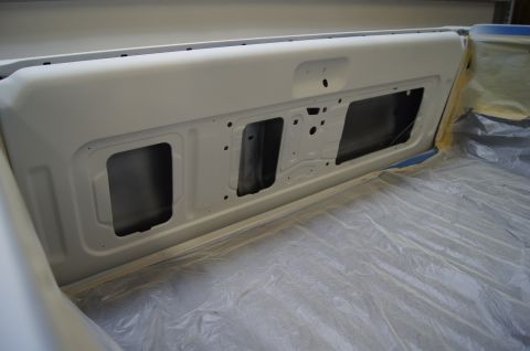 1979 Ford Bronco - Tailgate interior, prepped for paint, with plastic sheeting covering the bed.