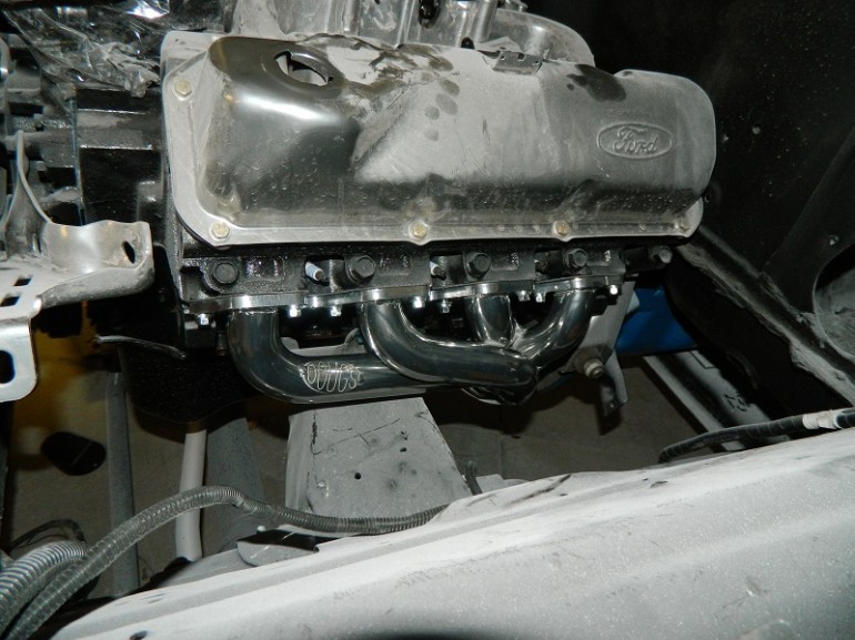 Ford V8 engine block with chrome headers and "Vortec" logo visible