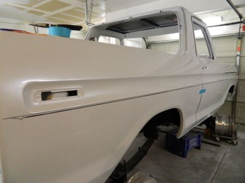 1979 Ford Bronco - 1979 Ford Bronco body undergoing restoration work in a garage.