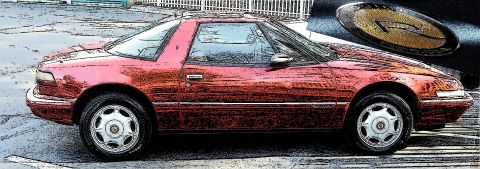 1991 Buick Reatta - Side view of a red 1991 Buick Reatta coupe with a distinctive oval emblem visible.