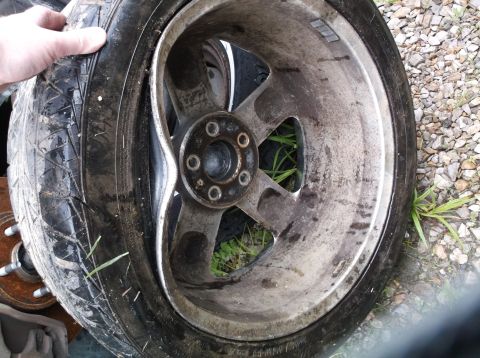 1999 Mercury Grand Marquis - A damaged tire and rim are shown, indicating a need for replacement.