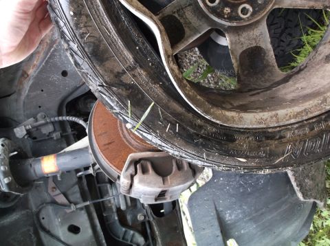 1999 Mercury Grand Marquis - A damaged tire and brake assembly are visible, with no clear indication of the vehicle's make or model.