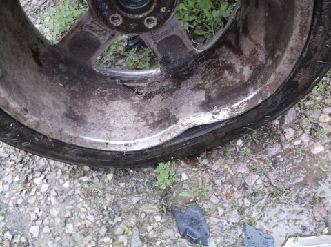 1999 Mercury Grand Marquis - This wheel has a bent rim and appears to have a flat tire.