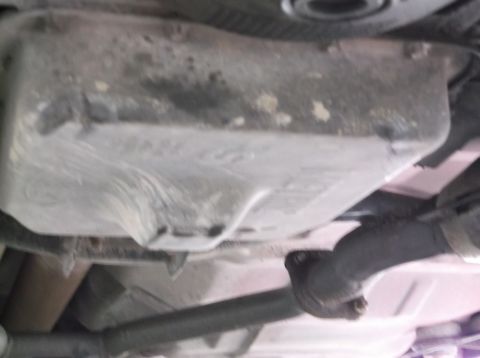 1999 Mercury Grand Marquis - Underside view of a vehicle's oil pan and exhaust pipe, with Supermotors.net logo.