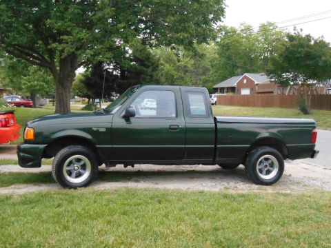 1997 Ford Ranger - This 1997 Ford Ranger pickup truck is shown from the side, parked on a grassy area.
