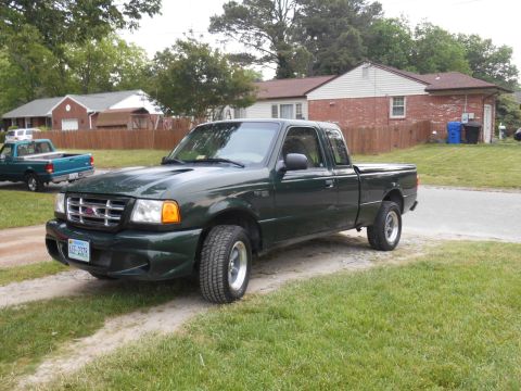 1997 Ford Ranger - 1997 Ford Ranger pickup truck parked in a residential area with another truck in the background.
