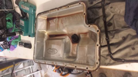 1996 Ford Bronco - Pan dropped. Fluid does not look too bad. Pan Magnet has collected typical sludge