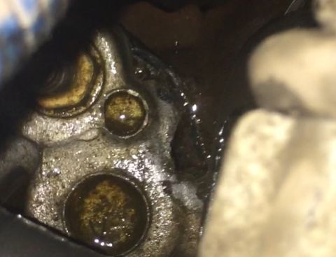 1996 Ford Bronco - This is a close-up view of an engine component, likely part of the intake system, with oil visible.