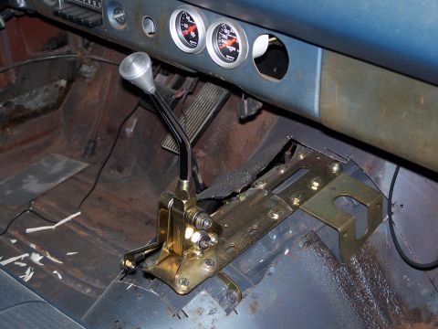 1971 Ford Ranchero - Interior view of a car's dashboard and floor, showing an aftermarket shifter and gauges.