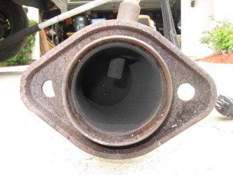 1994 Ford Bronco - This is a close-up view of a vehicle's exhaust pipe connection point.