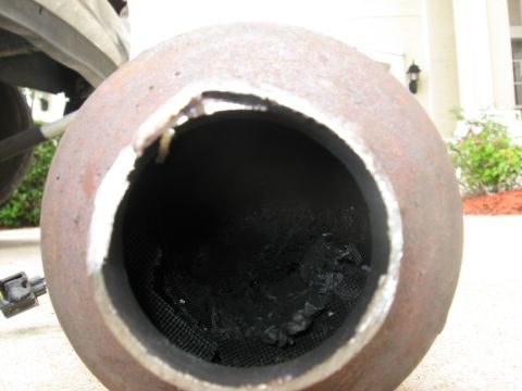 1994 Ford Bronco - Close-up of a damaged exhaust pipe, showing internal deterioration and external rust.