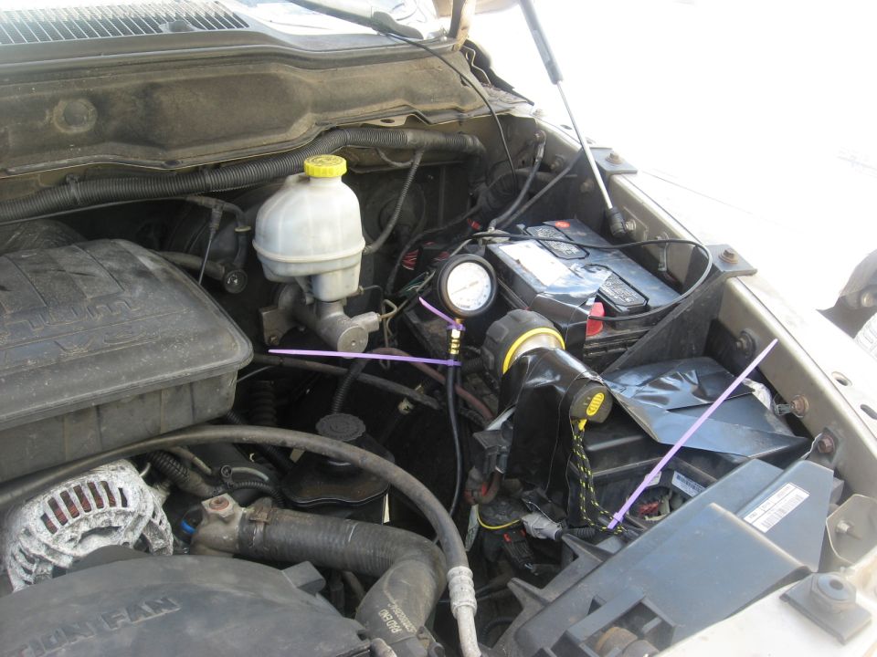 Engine bay with pressure gauge on brake fluid reservoir