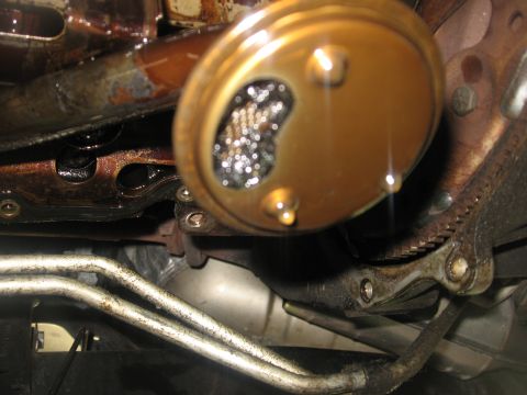 1994 Ford Bronco - This oil pump screen is clogged with metal particles, indicating potential engine wear.