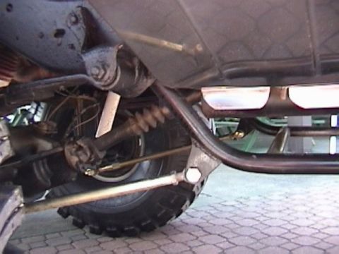 1995 Ford Bronco - The underside of a vehicle, focusing on the rear axle and suspension system.