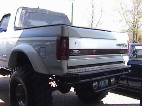 1995 Ford Bronco - Rear view of a lifted Ford Bronco with a custom bumper and aftermarket wheels.
