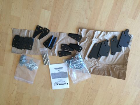 1997 Dodge 3500 - Unpacked TorkLift camper tie-down kit components including brackets, hardware, and instructions.