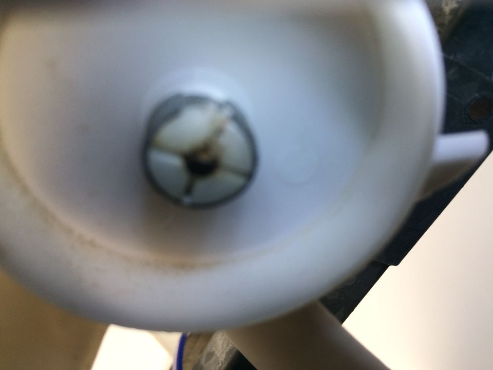 close-up of white plastic part with a screw head