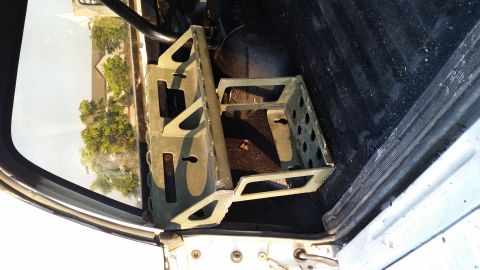 1993 Ford Bronco - A metal rack is installed inside the vehicle's cargo area, with a view of the exterior through the window.