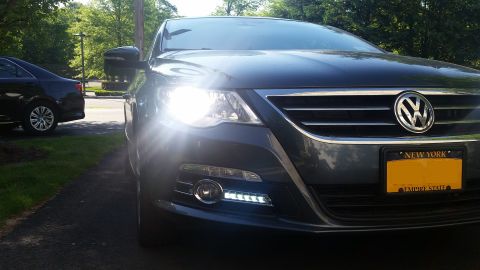 2010 Volkswagen Passat - A dark gray Volkswagen CC is parked in a driveway with its headlights illuminated.