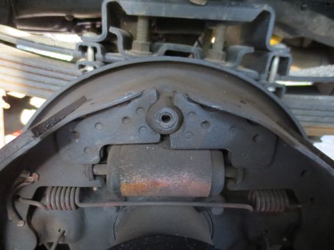 1994 Ford F-350 - This image shows the internal components of a vehicle's drum brake system, including the brake shoes and return springs.