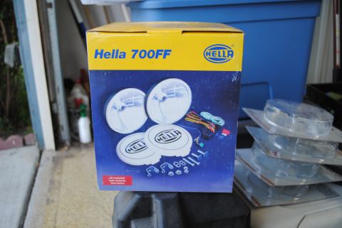 1986 Ford Bronco - A box of Hella 700FF lights is shown, along with other packaged lights and hardware.