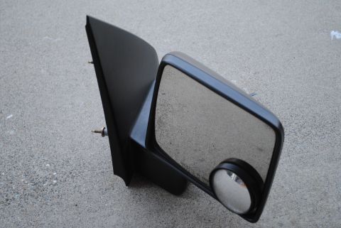 1986 Ford Bronco - A black side mirror assembly is shown against a concrete background.